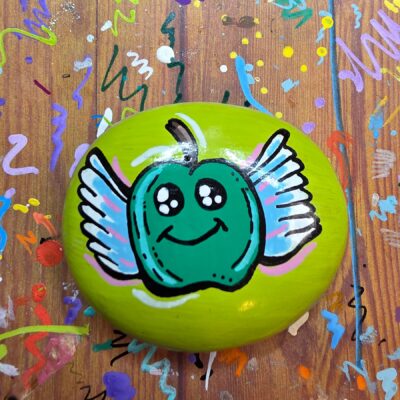 Painted Rock with a green apple with wings.
