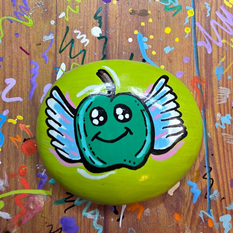 Painted Rock with a green apple with wings.